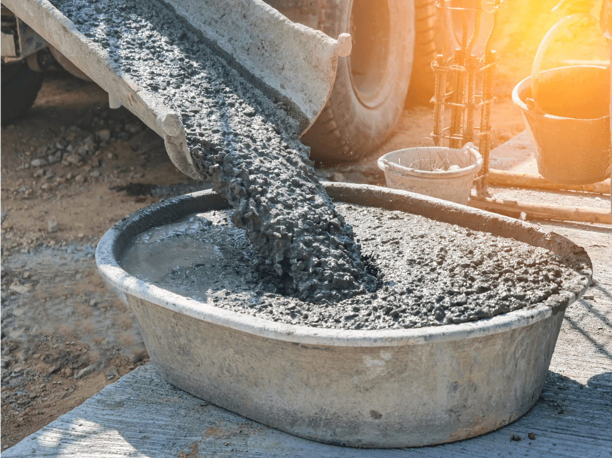 pouring concrete mix into large basin